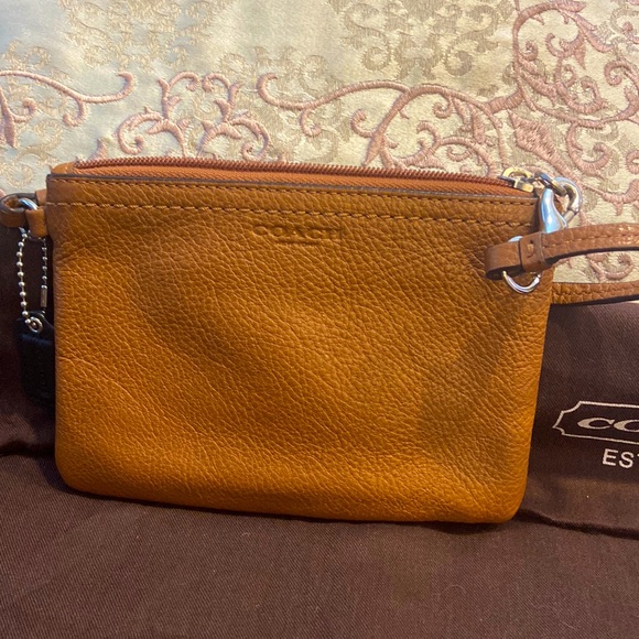 Coach Handbags - Pebble grain soft leather Coach wristlet. Tan.